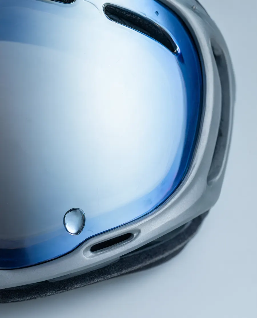 Close-up of a goggle lens with a water droplet